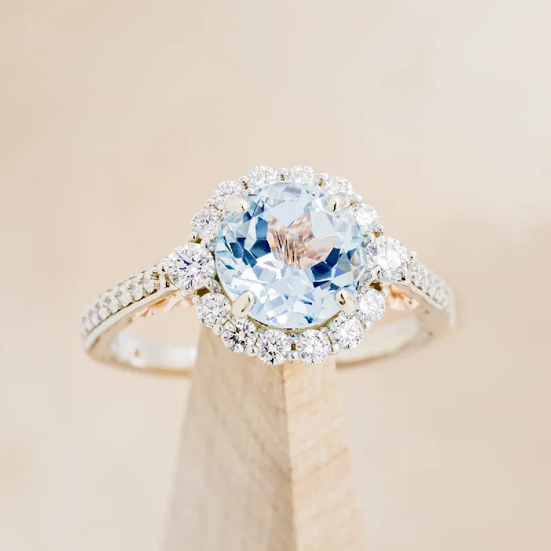 "OPHELIA" - ROUND CUT SKY BLUE TOPAZ ENGAGEMENT RING WITH DIAMOND HALO & ACCENTS